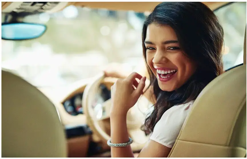 A person smiling in a car